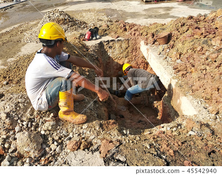 Workers repairing underground utility and services Workers repairing underground utility and services 45542940