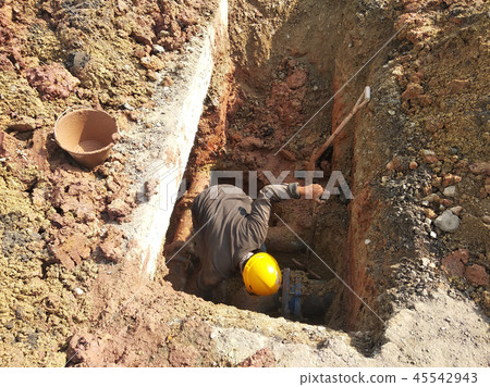 Workers repairing underground utility and services 45542943