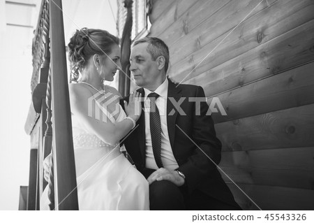 Wedding couple on the nature is hugging each other. Beautiful model girl in white dress. Man in suit Wedding couple on the nature is hugging each other. Beautiful model girl in white dress. Man in suit 45543326