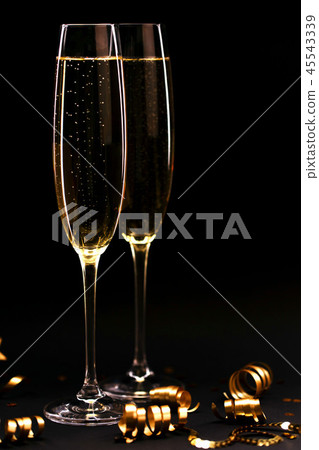 Two glasses of champagne full size on black background. Two glasses of champagne full size on black background. 45543339