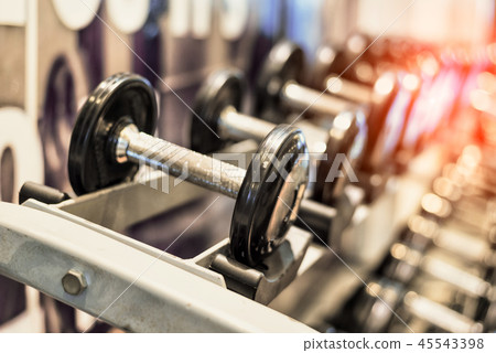 Close up of black metallic steel dumbbell set 45543398