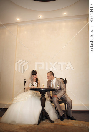 the bride and groom sign the document 45543410