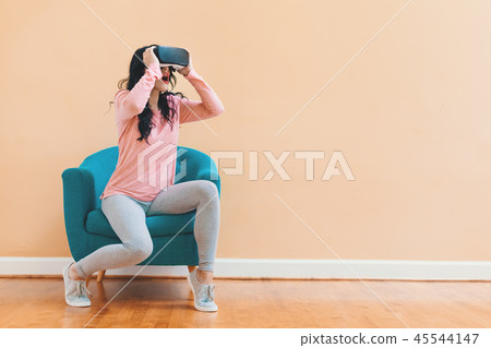 Young woman using a virtual reality headset 45544147