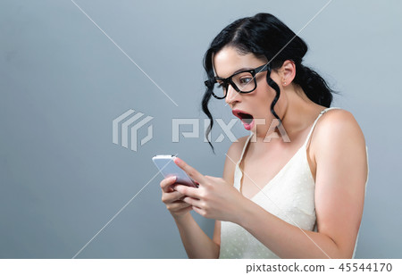 Young woman staring at her phone 45544170