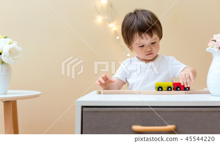 Toddler boy playing with his toys 45544220