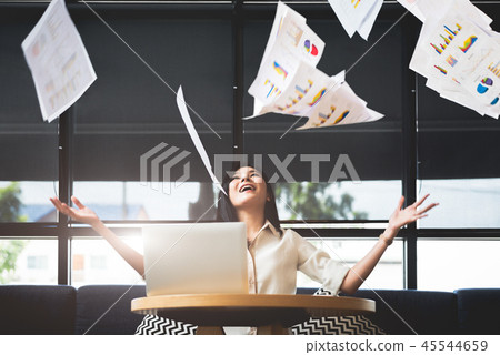 Asian businesswoman throwing paperwork into the air. Successful 45544659