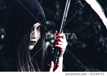 Female demon witch with bloody reaper standing in front of myste 45544725