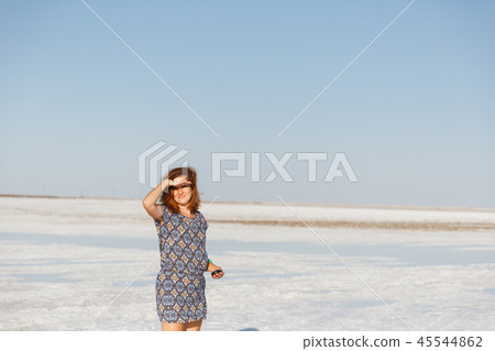 happy smiling girl enjoying sun, dancing and laughs, holds hand at his forehead happy smiling girl enjoying sun, dancing and laughs, holds hand at his forehead 45544862