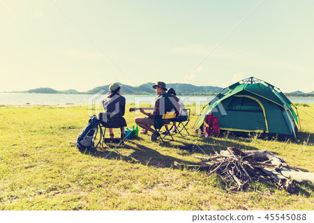 Group of travelers camping and doing picnic and playing music to Group of travelers camping and doing picnic and playing music to 45545088