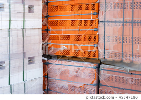 Stock pallets of red bricks wrapped in stretch film at wholesale outdoor market ot store Stock pallets of red bricks wrapped in stretch film at wholesale outdoor market ot store 45547180