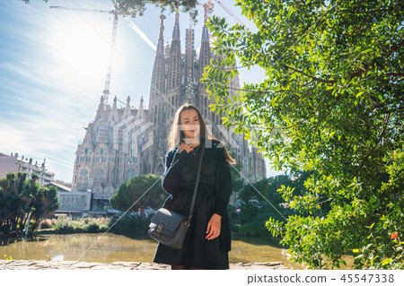 beautiful girl posing behind amazing gothic church in europe 45547338