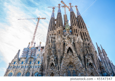 Frontal view of Sagrada Familia. cranes are still working 45547347