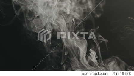 closeup vapor rises from bottom on black background 45548158