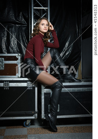 girl in sweater, leather shorts and overknee boots 45548313