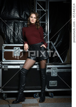 girl in sweater, leather shorts and overknee boots 45548314