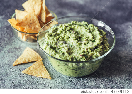 Guacamole in the glass bowl with tortilla chips 45549110