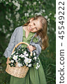 The child enjoys the spring and a basket of flower 45549222
