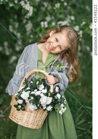 The child enjoys the spring and a basket of flower 45549222
