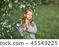 Portrait of a little girl in spring in flowering  45549225