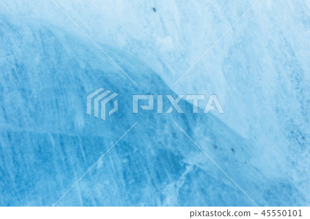 Close-up blurred wall of a centuries-old glacier with a structure of stripes and bubbles. Ice blue Close-up blurred wall of a centuries-old glacier with a structure of stripes and bubbles. Ice blue 45550101
