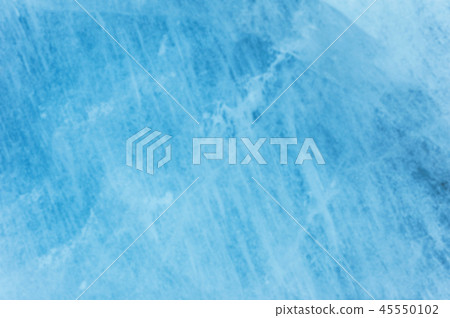 Close-up blurred wall of a centuries-old glacier with a structure of stripes and bubbles. Ice blue 45550102