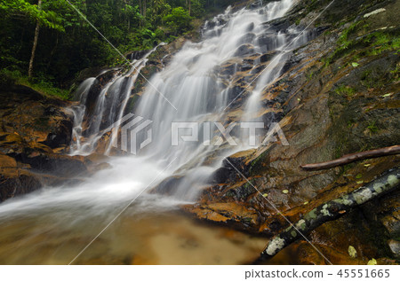 Beautiful tropical waterfall in lush green forest. Beautiful tropical waterfall in lush green forest. 45551665