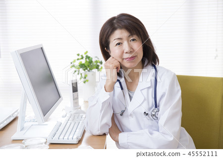 Female doctor sticking a cheek cane Female doctor sticking a cheek cane 45552111