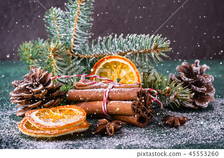 Christmas greeting card with cinnamon, dry oranges and spruce branches Christmas greeting card with cinnamon, dry oranges and spruce branches 45553260