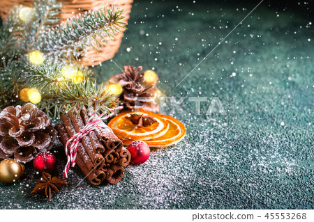 Christmas greeting card. Cinnamon sticks, fir branches and dry oranges Christmas greeting card. Cinnamon sticks, fir branches and dry oranges 45553268