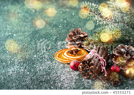 Christmas natural holiday composition with cinnamon, pine cones and dry oranges Christmas natural holiday composition with cinnamon, pine cones and dry oranges 45553271