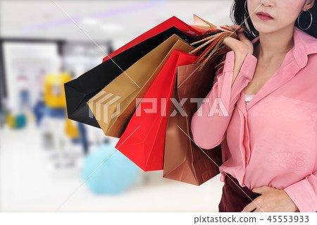 woman holding shopping bag at mall woman holding shopping bag at mall 45553933