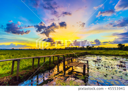100 year-old wooden bridge with sunset at Khonburi, Nakhon Ratch 100 year-old wooden bridge with sunset at Khonburi, Nakhon Ratch 45553941