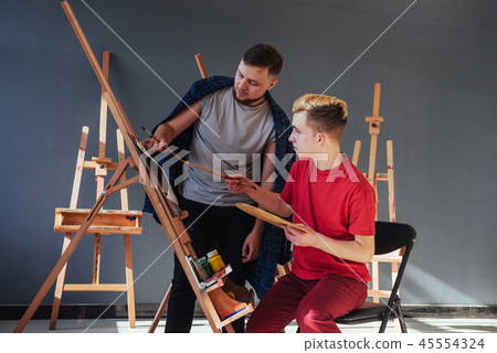 Creative artists have designed a colorful picture painted on canvas with oil paints in the studio Creative artists have designed a colorful picture painted on canvas with oil paints in the studio 45554324