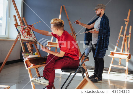 Creative artists have designed a colorful picture painted on canvas with oil paints in the studio Creative artists have designed a colorful picture painted on canvas with oil paints in the studio 45554335