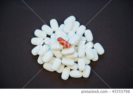 Medical colorful pills, capsules or supplements for the treatment and health care on a black Medical colorful pills, capsules or supplements for the treatment and health care on a black 45555798