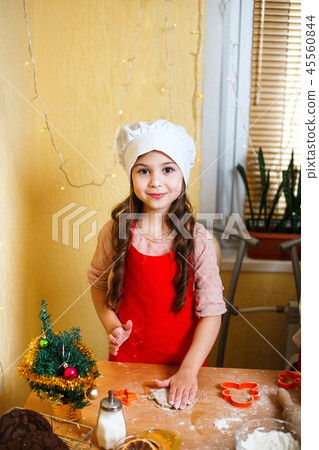 Merry Christmas and Happy Holidays. Mother and daughter cooking Christmas cookies. Merry Christmas and Happy Holidays. Mother and daughter cooking Christmas cookies. 45560844