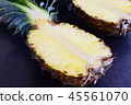Halves of pineapple on black concrete background. 45561070