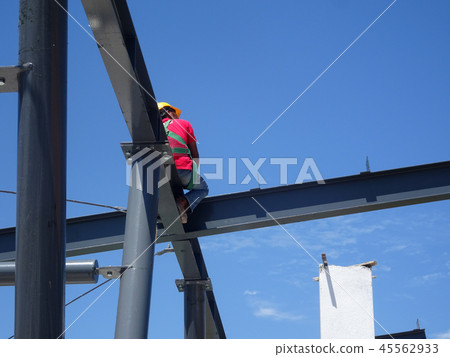Workers fabricating mild steel roof trusses. Workers fabricating mild steel roof trusses. 45562933