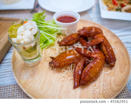 Grilled chicken wings with tomato sauce on the tab 45562951