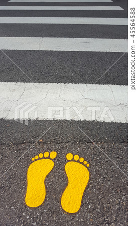 Crosswalk in front of the school Yellow footprints 45564588
