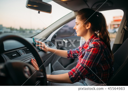 Woman polishes the torpedo on car wash Woman polishes the torpedo on car wash 45564983