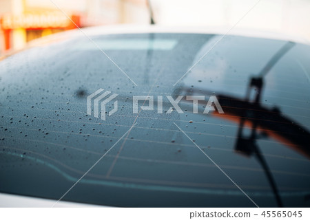 Car rear glass with drops of wax, waxing process Car rear glass with drops of wax, waxing process 45565045