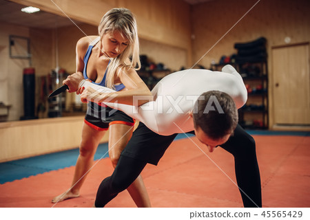 Woman makes elbow kick, self-defense workout Woman makes elbow kick, self-defense workout 45565429