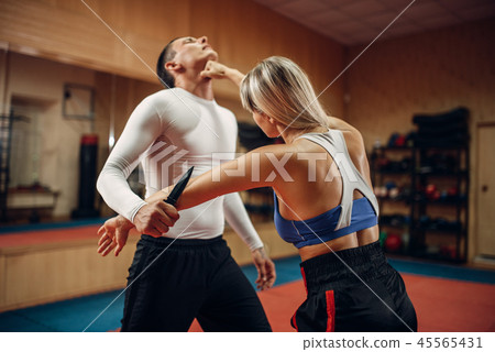 Woman makes punch to the throat, self-defense Woman makes punch to the throat, self-defense 45565431