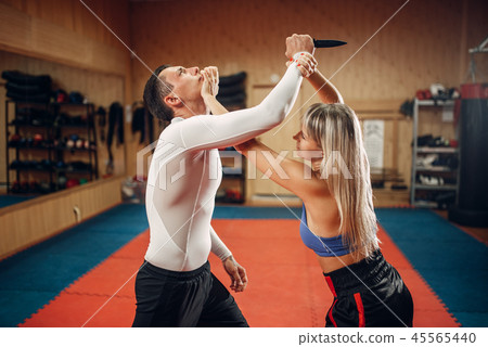 Woman makes punch to the throat, self-defense Woman makes punch to the throat, self-defense 45565440