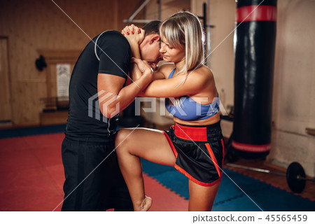 Female person on self defense training, knee kick Female person on self defense training, knee kick 45565459