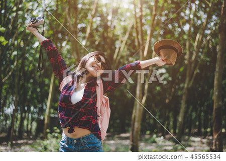 Happiness Asian traveler woman in forest with spread arms and en 45565534