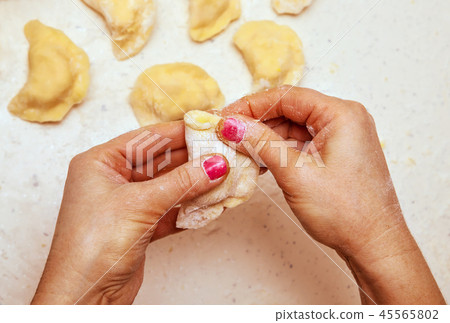 hands of chef who prepares ravioli  45565802