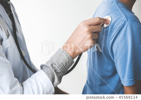 Doctor checking patient with stethoscope listening to heartbeat, 45569114