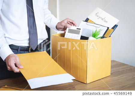 Businessman sending letter will being resignation and carrying p 45569149